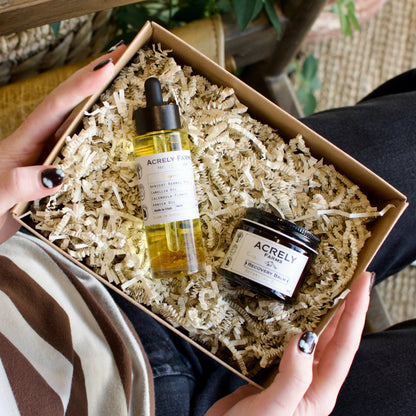 Person holding a box with skincare products from Acrely Farms.